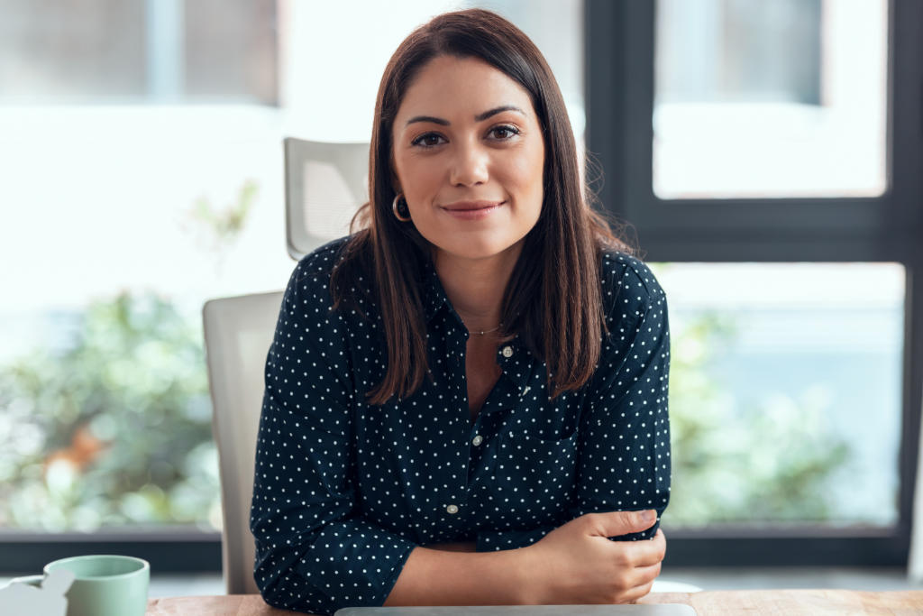 Confident business woman looking and speaking through the webcam